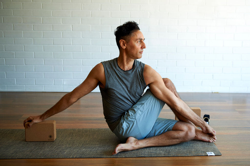 man-practicing-yoga-at-home